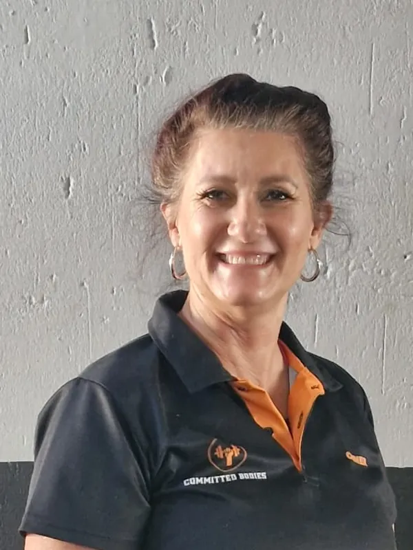 Jill, smiling, in a Committed Bodies coach shirt
